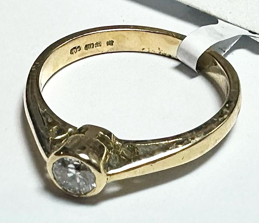 18ct yellow gold diamond ring in size L 1/2, showcasing a sparkling diamond set in a classic band style.