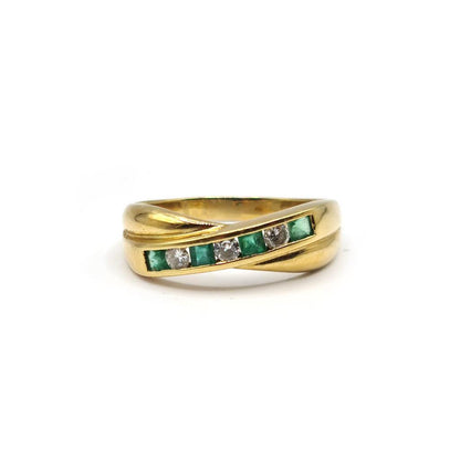 18ct yellow gold emerald and diamond half eternity ring with alternating gemstones and a sleek, polished band.