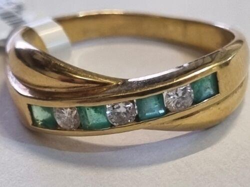 18ct yellow gold emerald and diamond half eternity ring with alternating gemstones and a sleek band design.