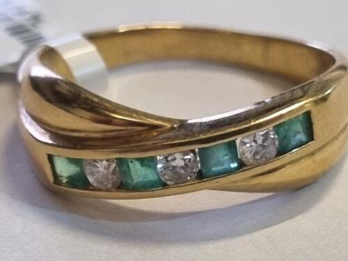 18ct yellow gold emerald and diamond half eternity ring with alternating gemstones and a polished band.