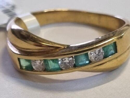 18ct yellow gold emerald and diamond half eternity ring with alternating gemstones and a polished band.