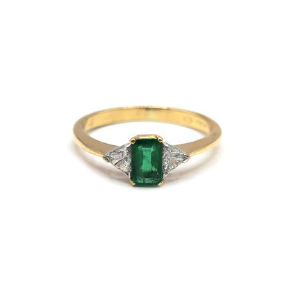 18ct yellow gold emerald and diamond ring featuring a central emerald and sparkling diamonds, unbranded jewelry accessory.