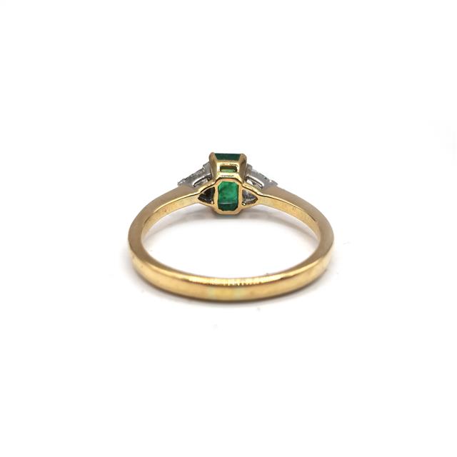 18ct yellow gold ring with emerald and diamond accents, featuring a delicate band and intricate gemstone detailing.