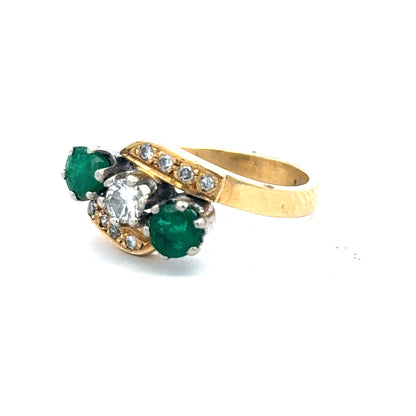 18ct yellow gold emerald and diamond ring, size N, featuring a central emerald surrounded by sparkling diamonds.