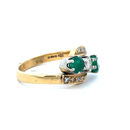 18ct yellow gold emerald and diamond ring, size N, featuring a central emerald gemstone surrounded by sparkling diamonds.