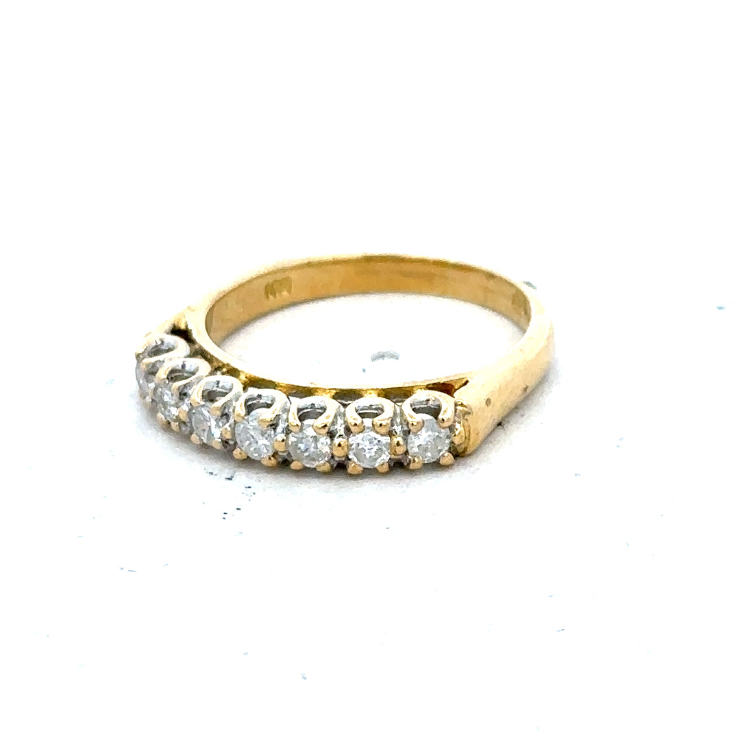 18ct yellow gold half eternity diamond ring with sparkling diamonds, showcasing a luxurious and elegant jewelry design.