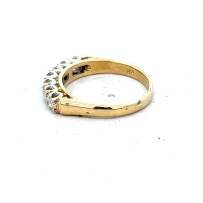 18ct yellow gold half eternity diamond ring with sparkling diamonds encircling the band, showcasing elegant jewelry design.