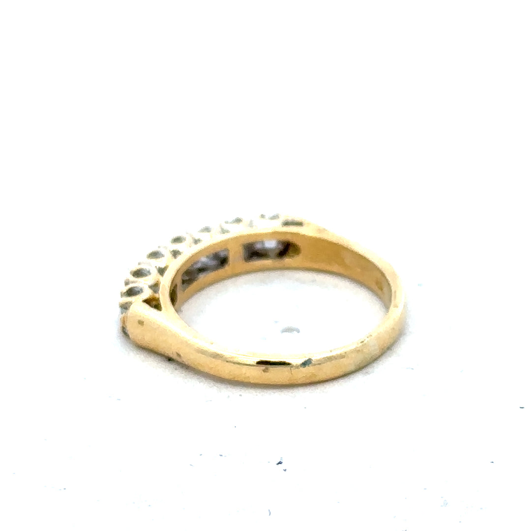 18ct yellow gold half eternity diamond ring with a row of sparkling diamonds, showcasing a luxurious and elegant jewelry design.