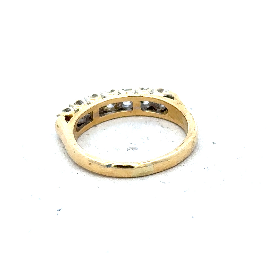 18ct yellow gold half eternity diamond ring showing a band with small sparkling diamonds around the gold.