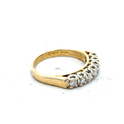 18ct yellow gold half eternity diamond ring with sparkling diamonds set in a sleek band.
