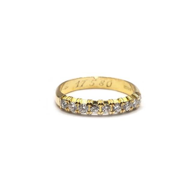 18ct yellow gold half eternity diamond ring with sparkling diamonds, showcasing a sleek and elegant jewelry design.