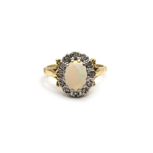 18ct yellow gold opal and diamond ring featuring a vibrant opal gemstone and sparkling diamonds on a sleek gold band.