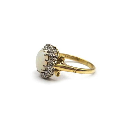 18ct yellow gold ring featuring a vibrant opal and sparkling diamonds, elegant jewelry piece with intricate design.