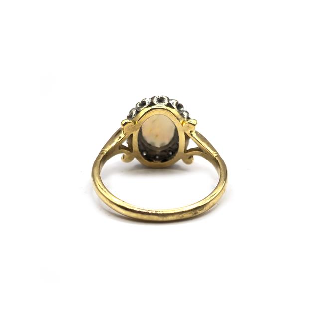 18ct yellow gold opal and diamond ring with a polished band and sparkling gemstones, unbranded jewelry design.