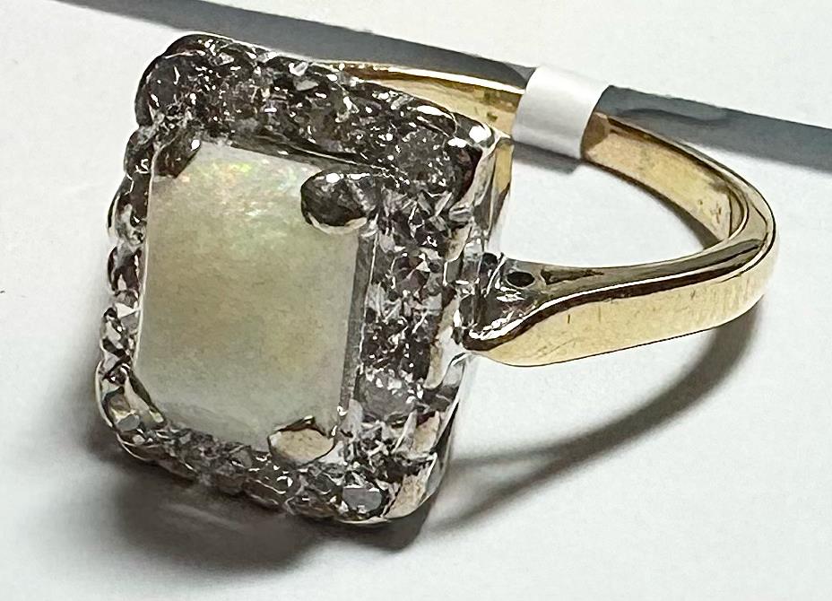 18ct yellow gold opal and diamond ring in size N½, featuring a vibrant opal centerpiece and sparkling diamonds.