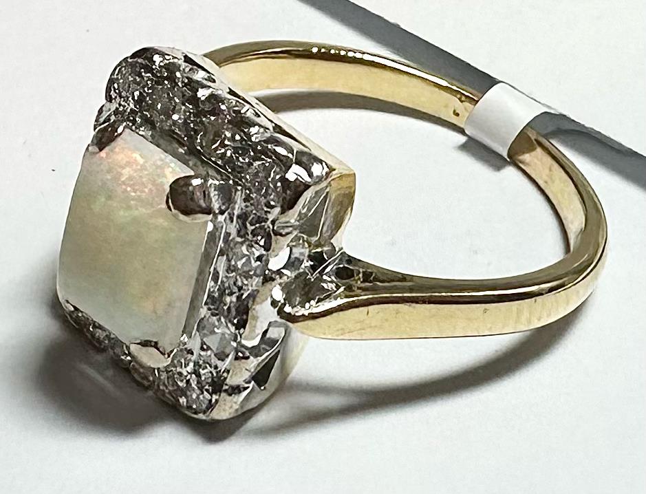 18ct yellow gold opal and diamond ring in size N1/2 featuring a colorful opal centerpiece and sparkling diamonds.
