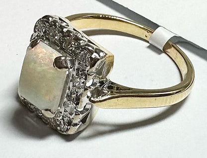 18ct yellow gold opal and diamond ring in size N1/2 featuring a colorful opal centerpiece and sparkling diamonds.