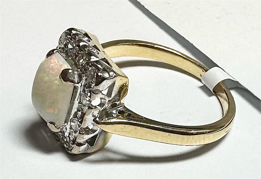 18ct yellow gold opal and diamond ring, size N1/2, showcasing a vibrant opal and sparkling diamonds on a polished gold band.