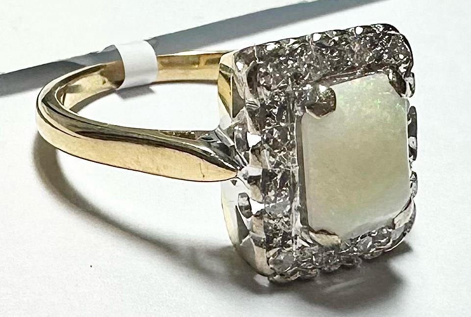 18ct yellow gold opal and diamond ring, size N1/2, featuring a colorful opal center with sparkling diamonds.