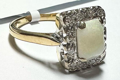 18ct yellow gold opal and diamond ring, size N1/2, featuring a colorful opal center with sparkling diamonds.