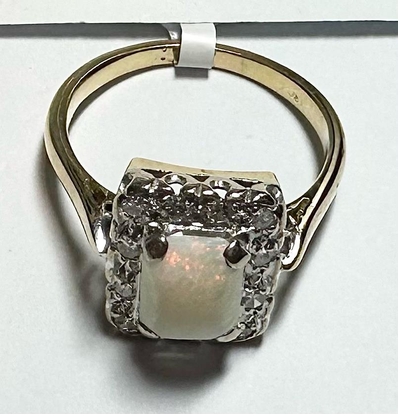 18ct yellow gold opal and diamond ring in size N1/2 featuring a vibrant opal center and sparkling diamonds.