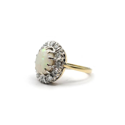 18ct yellow gold oval ring featuring a 1.85 carat opal and 0.60 carat diamond accents, elegant jewelry piece.