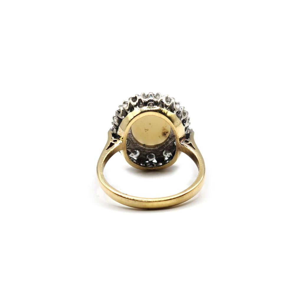 18ct yellow gold oval opal and diamond ring with 1.85 carats of opal and 0.60 carats of diamonds, featuring a classic design.