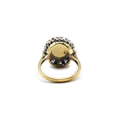 18ct yellow gold oval opal and diamond ring with 1.85 carats of opal and 0.60 carats of diamonds, featuring a classic design.