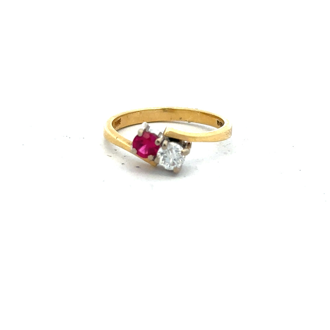 18ct yellow gold ruby and diamond ring in size L, featuring a central ruby surrounded by sparkling diamonds.