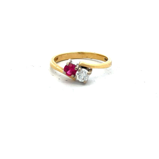 18ct yellow gold ruby and diamond ring in size L, featuring a central ruby surrounded by sparkling diamonds.
