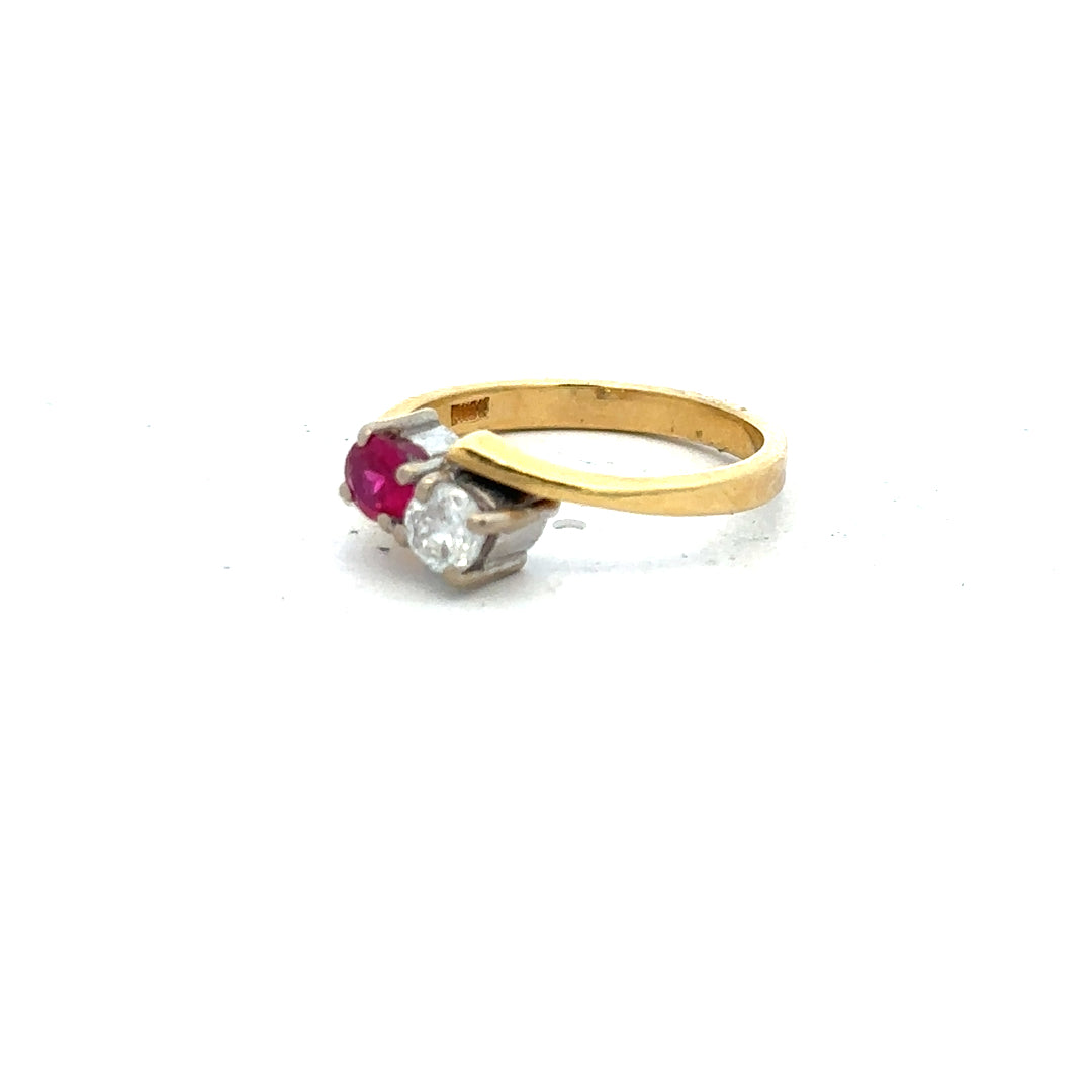 18ct yellow gold ruby and diamond ring, size L, featuring a central ruby gemstone surrounded by sparkling diamonds.