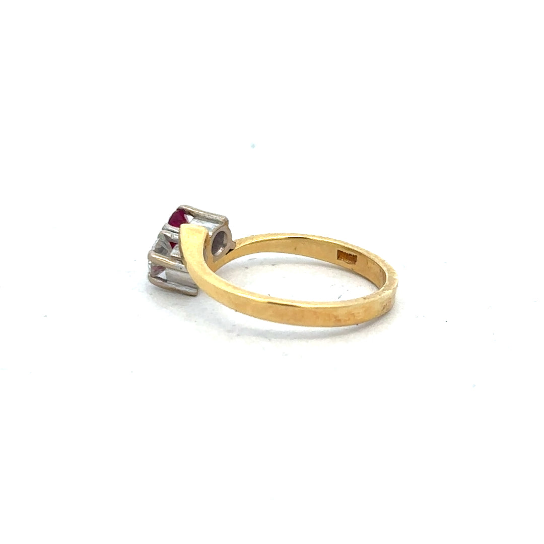 18ct yellow gold ruby and diamond ring in size L, featuring a central ruby surrounded by sparkling diamonds.
