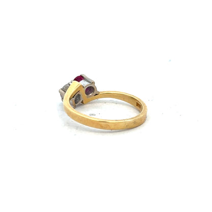 18ct yellow gold ruby and diamond ring in size L, featuring a central ruby surrounded by sparkling diamonds.