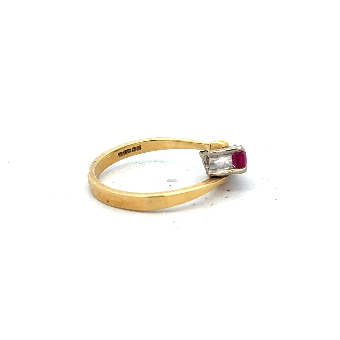 18ct yellow gold ruby and diamond ring in size L, featuring a central ruby surrounded by sparkling diamonds.