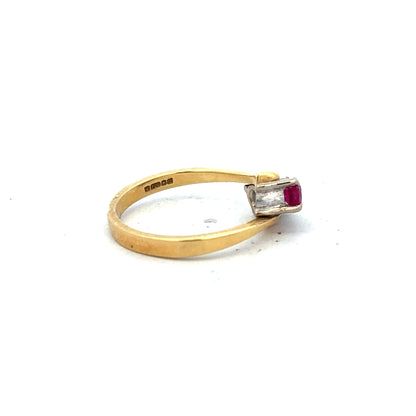 18ct yellow gold ruby and diamond ring in size L, featuring a central ruby surrounded by sparkling diamonds.