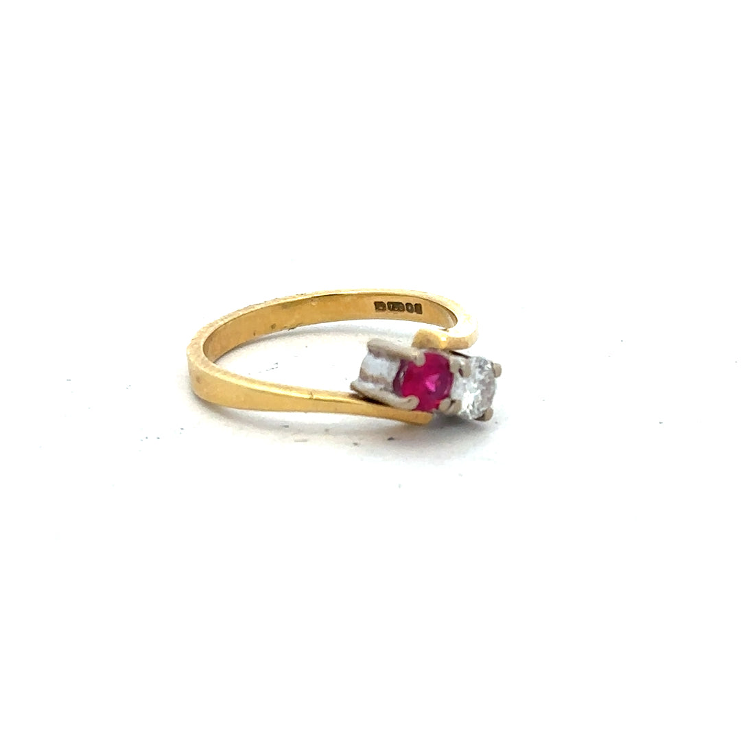 18ct yellow gold ruby and diamond ring in size L, featuring a central ruby surrounded by sparkling diamonds.