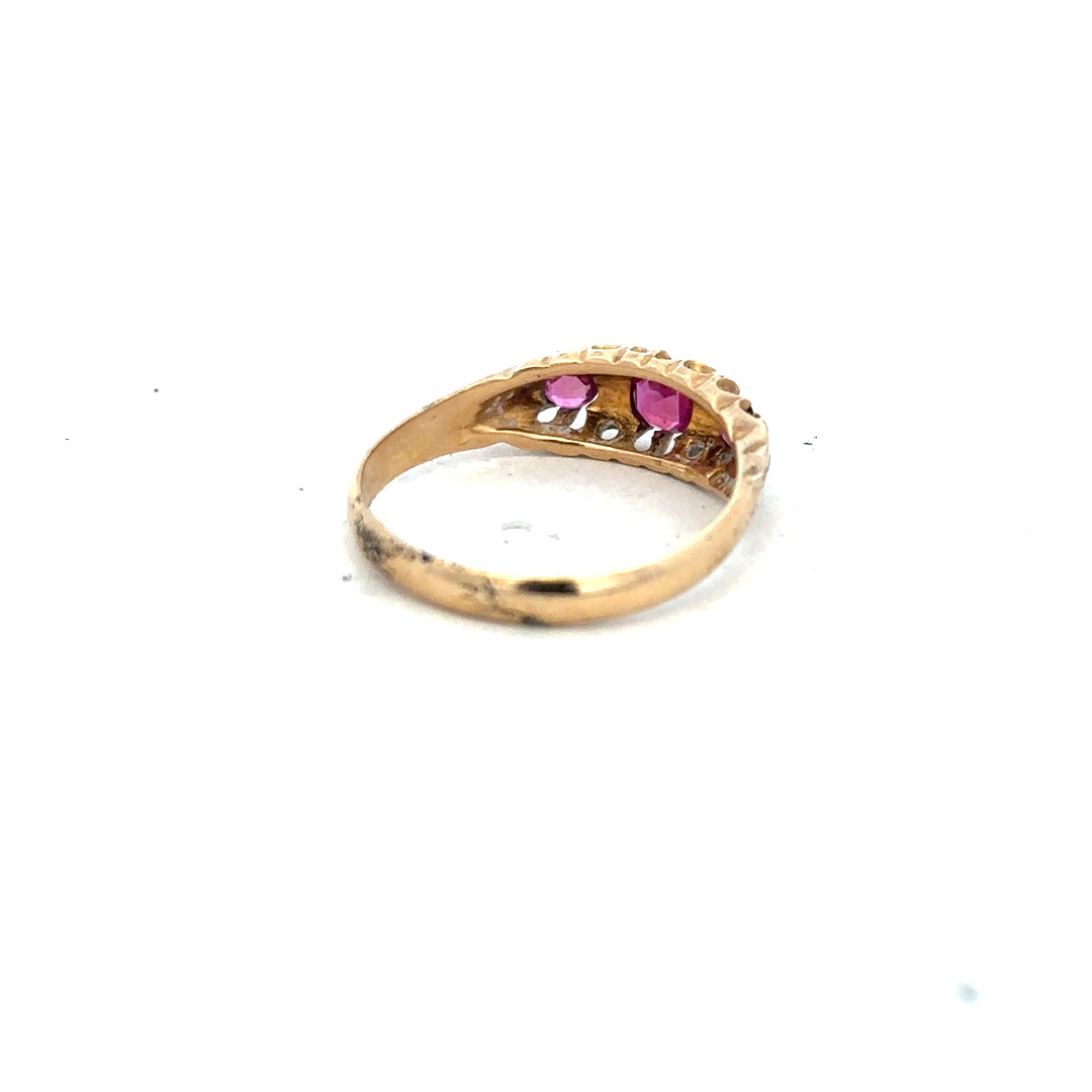 18ct yellow gold ruby and diamond ring in size P, featuring a central ruby with surrounding diamonds on an elegant gold band.