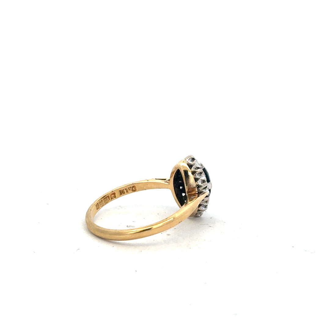 18ct yellow gold sapphire and diamond ring, size M, featuring a central blue sapphire surrounded by sparkling diamonds.