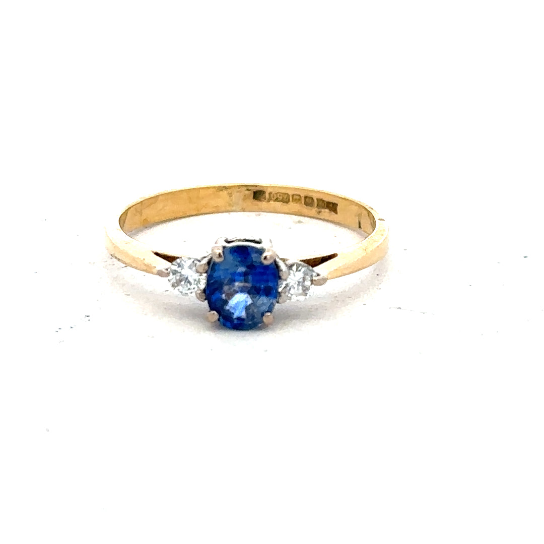 18ct yellow gold sapphire and diamond ring in size M, featuring a central sapphire surrounded by diamonds, elegant jewelry piece