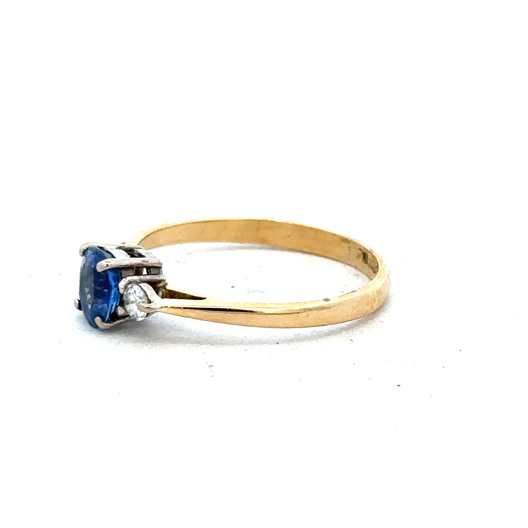 18ct yellow gold sapphire and diamond ring, size M, featuring a central blue sapphire with surrounding diamonds, elegant jewelry piece.