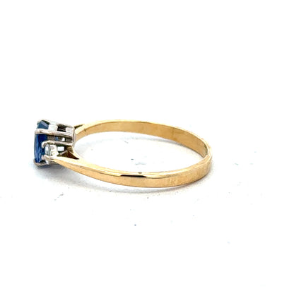 18ct yellow gold sapphire and diamond ring, size M, featuring a central sapphire with diamond accents on a sleek gold band.