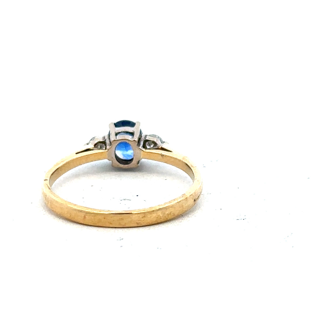 18ct yellow gold sapphire and diamond ring, size M, showcasing a gold band with a central sapphire and sparkling diamonds.