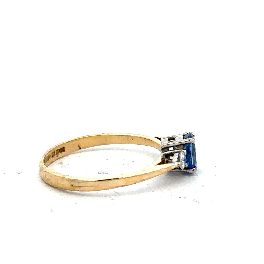 18ct yellow gold sapphire and diamond ring, size M, featuring a central sapphire gemstone surrounded by diamonds.