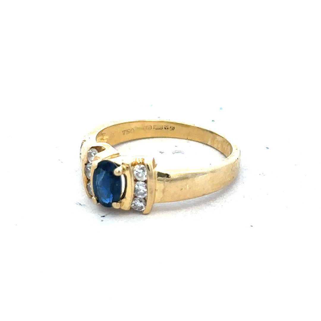 18ct yellow gold sapphire and diamond ring, size M, featuring a central sapphire gemstone surrounded by diamonds.