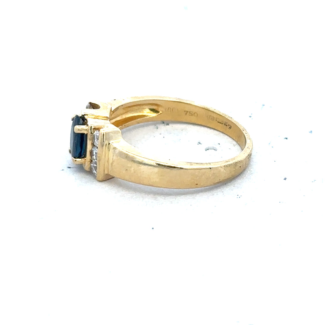 18ct yellow gold sapphire and diamond ring in size M, featuring a central sapphire surrounded by sparkling diamonds.