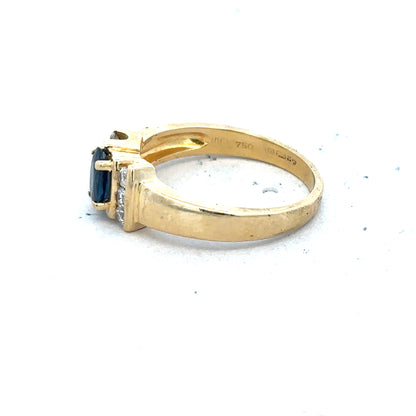 18ct yellow gold sapphire and diamond ring in size M, featuring a central sapphire surrounded by sparkling diamonds.