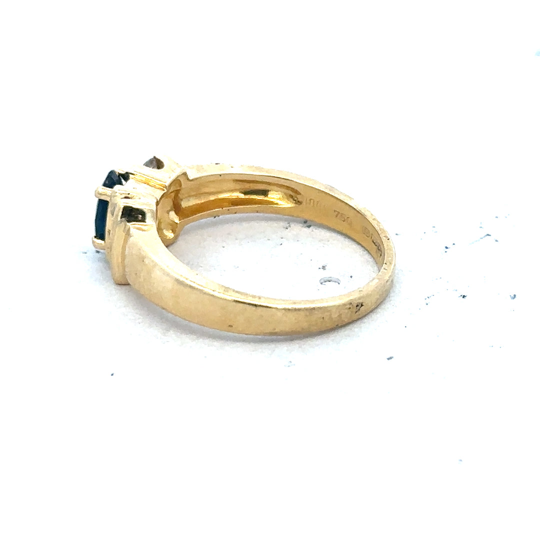 18ct yellow gold sapphire and diamond ring, size M, featuring a central sapphire gemstone with surrounding diamonds.