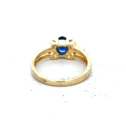 18ct yellow gold sapphire and diamond ring in size M, featuring a central sapphire gemstone and sparkling diamonds.