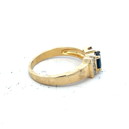 18ct yellow gold sapphire and diamond ring in size M, featuring a central sapphire with surrounding diamonds on a sleek band.