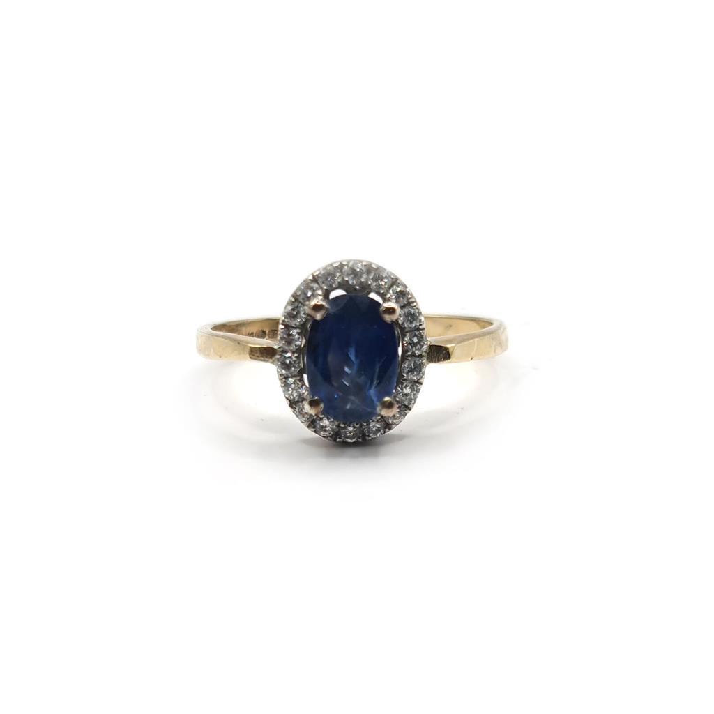 18ct yellow gold sapphire and diamond ring with a central blue sapphire and sparkling diamonds, elegant jewelry piece.